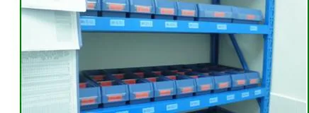 The same shelving reorganized into uniform labelled parts bins in tidy rows.