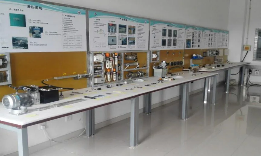 In-plant training room with hydraulic and pneumatic component display boards and hands-on benches.