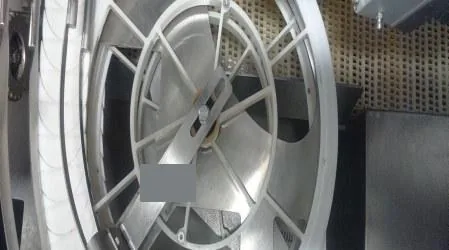 Close-up of a filling valve wheel assembly inside the machine.